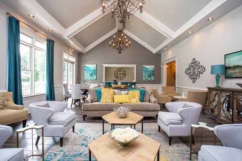 a living room with couches and chairs and a chandelier